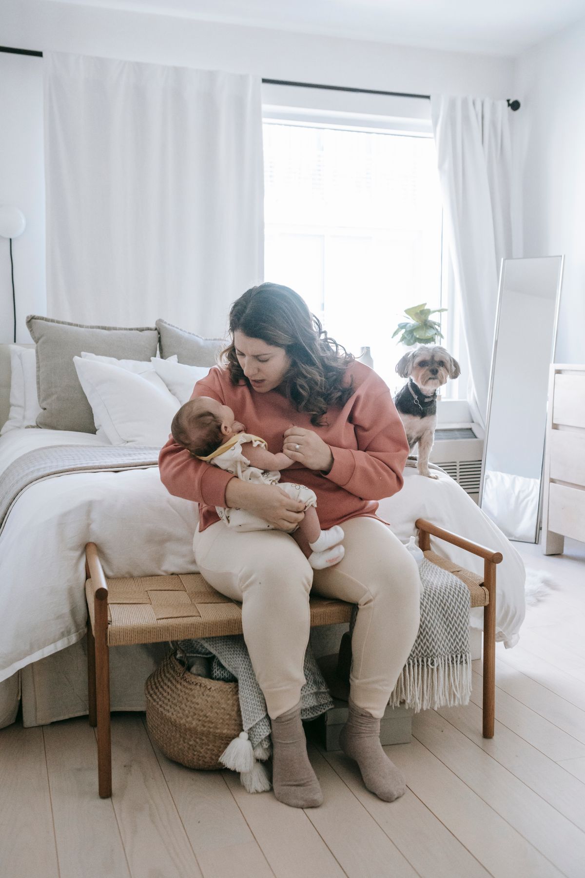Mother holding her baby at home