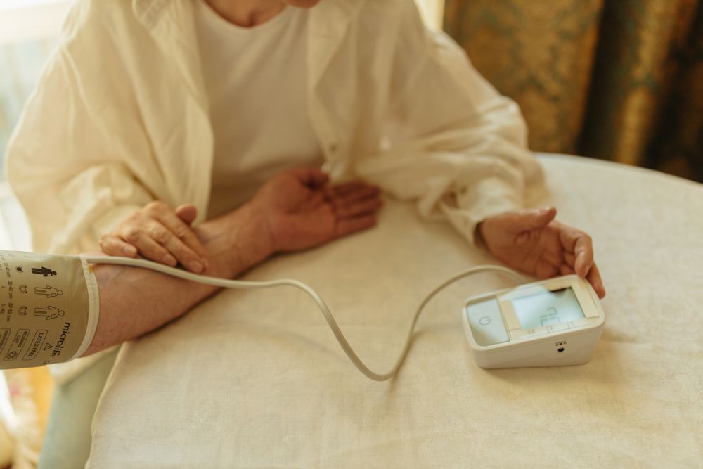 Person using a digital blood pressure monitor at home