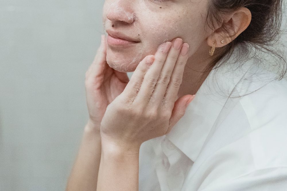 Woman cleansing her face as part of a personal-care routine